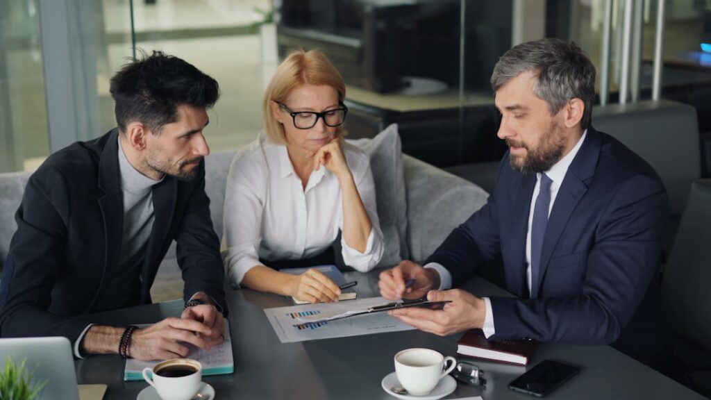 Small business owner meeting with a bank loan officer to discuss refinancing options