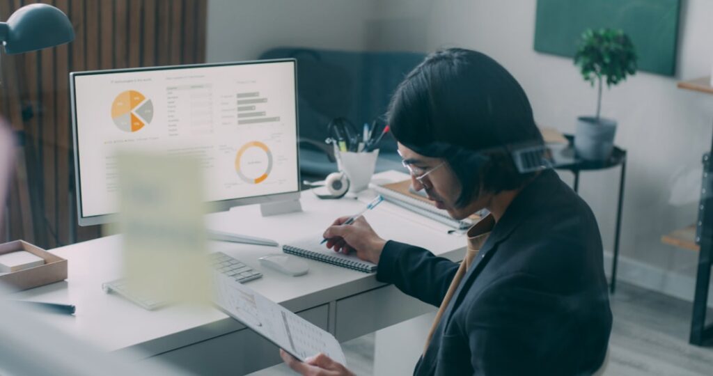 MCA funder reviewing business advance application documents at a desk