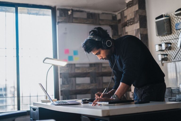 Small business owner comparing financing options at desk with calculator and documents