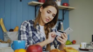 Small business owner reviewing daily bank debits and MCA payment statements