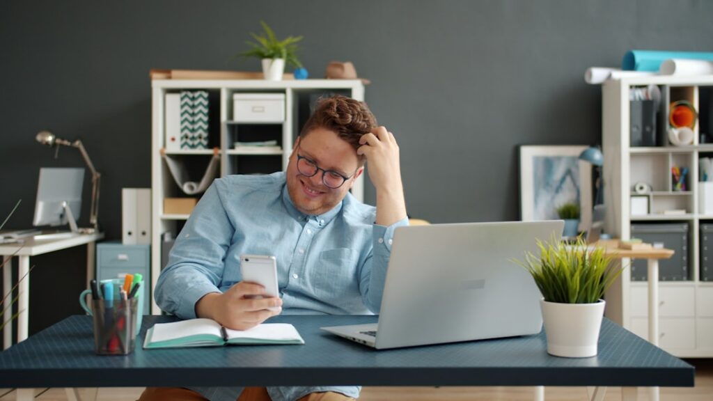 Business owner overwhelmed by multiple MCA debt invoices at desk