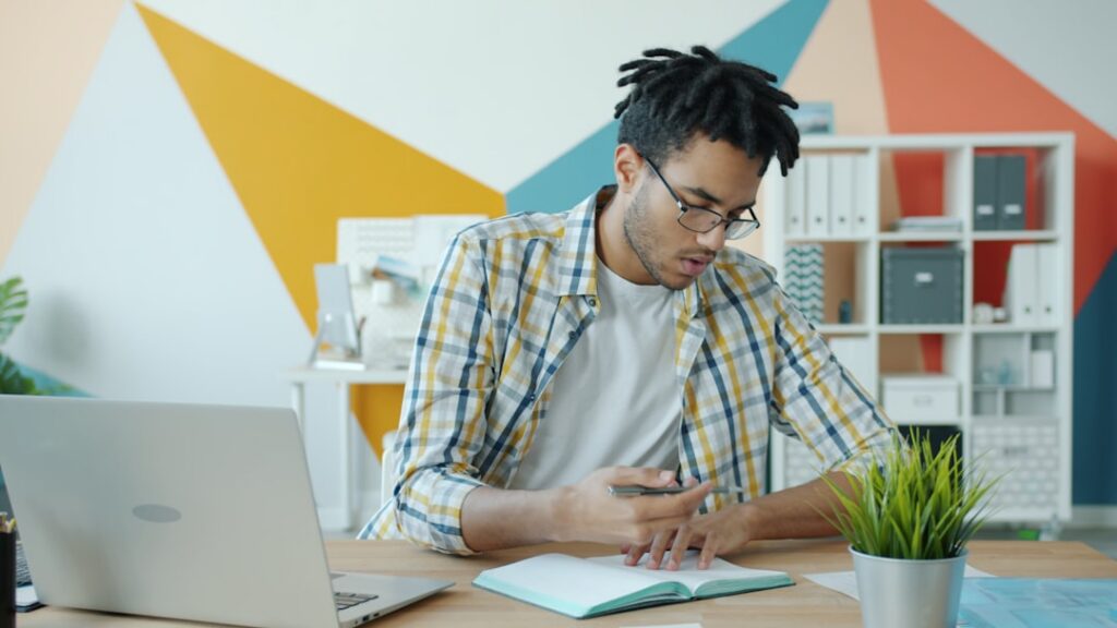 Franchise agreement and MCA contract paperwork being reviewed at a small business desk