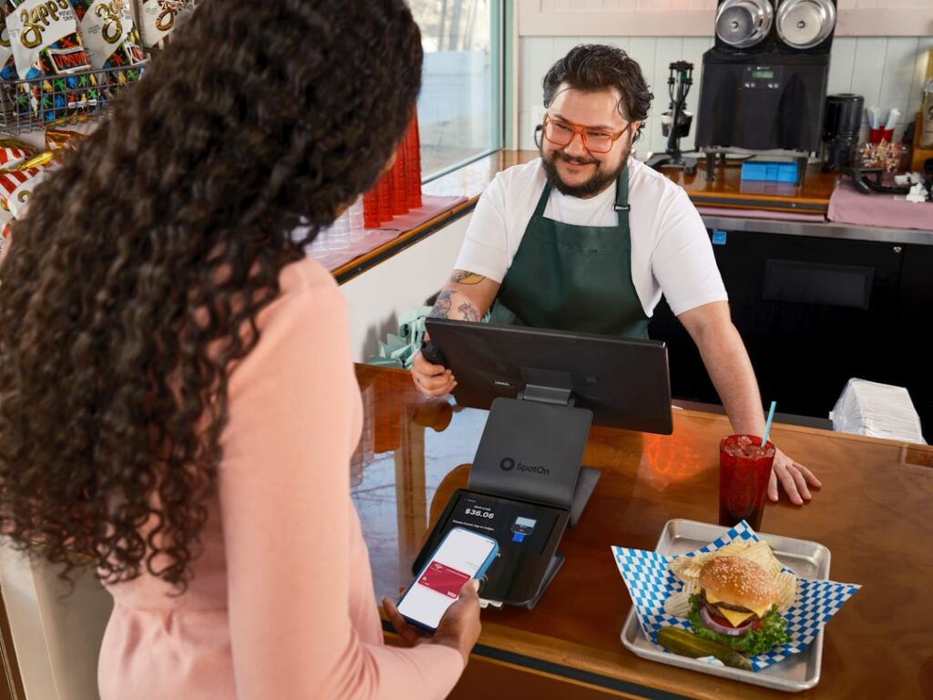 Franchise owner reviewing MCA debt paperwork at business location