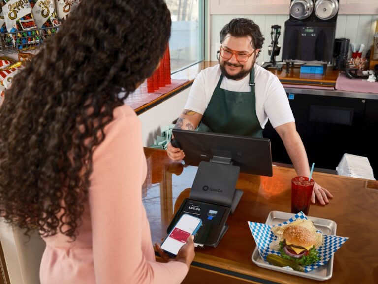 Franchise owner reviewing MCA debt paperwork at business location