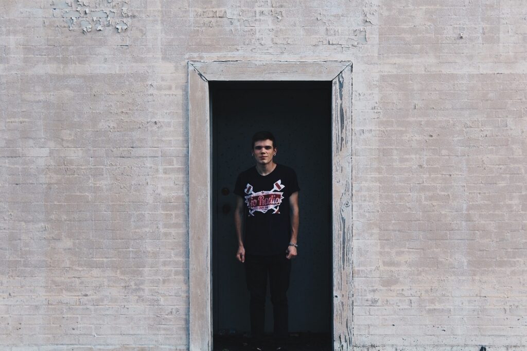 Confident daycare center owner standing in a classroom doorway
