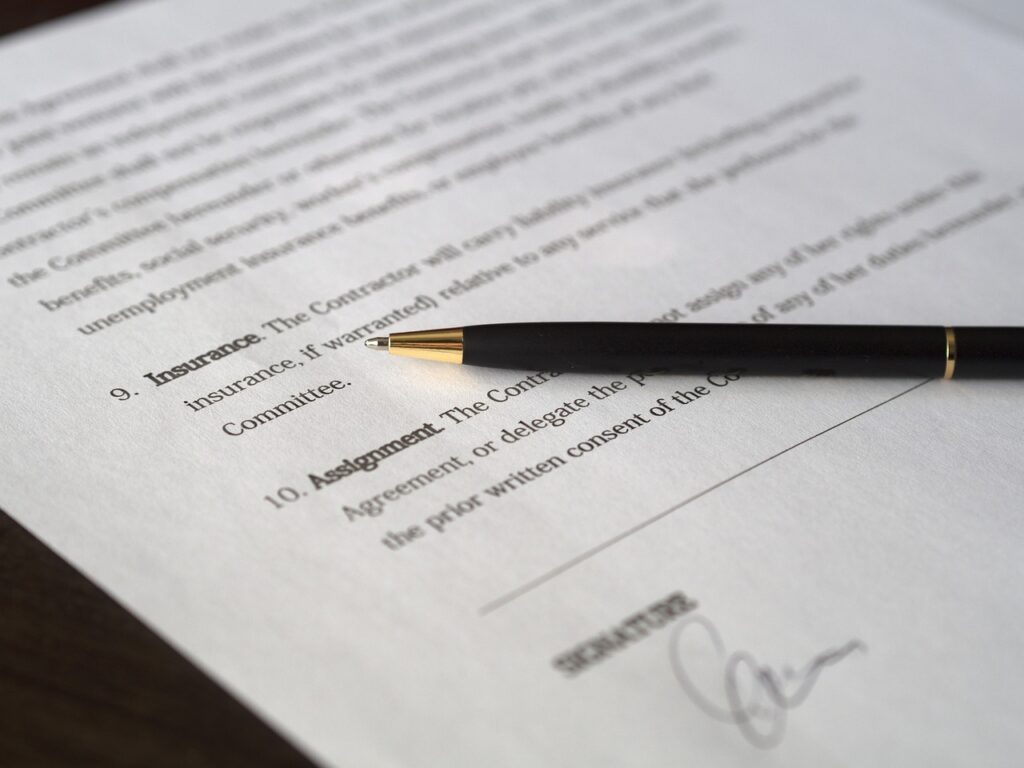 Business owner and lender reviewing UCC filing paperwork together at a table