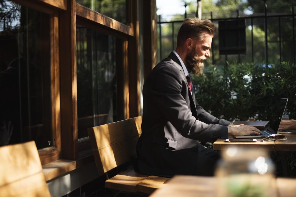 Business owner reviewing revenue numbers on a laptop at a kitchen table