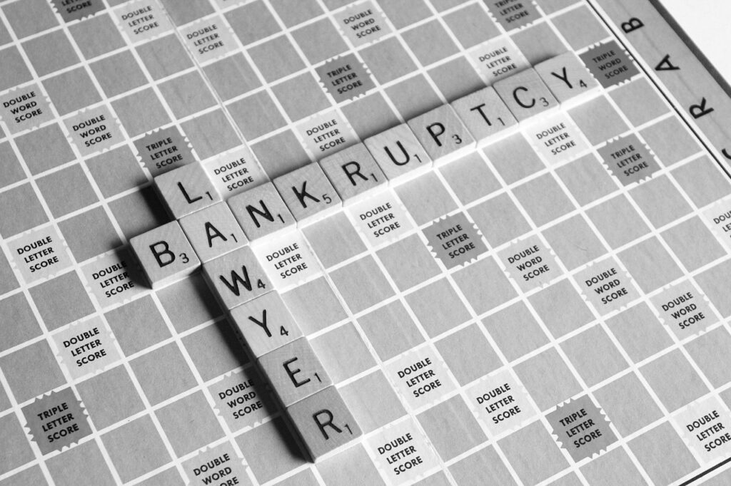 Person reviewing bankruptcy forms with a calculator on the desk