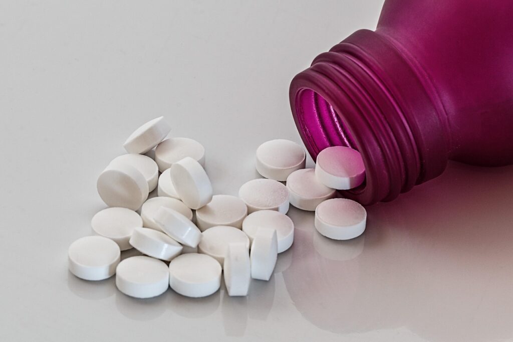Confident independent pharmacist standing in front of pharmacy shelves
