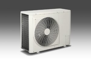 HVAC technician servicing a rooftop air conditioning unit during peak summer season