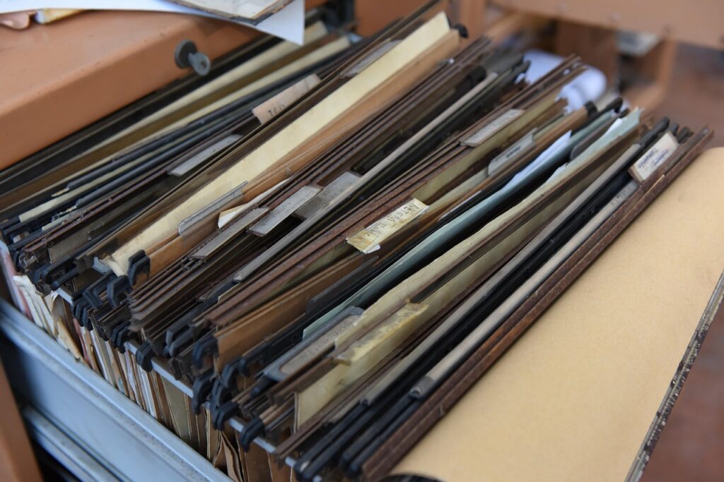 Business owner organizing financial documents into clearly labeled folders