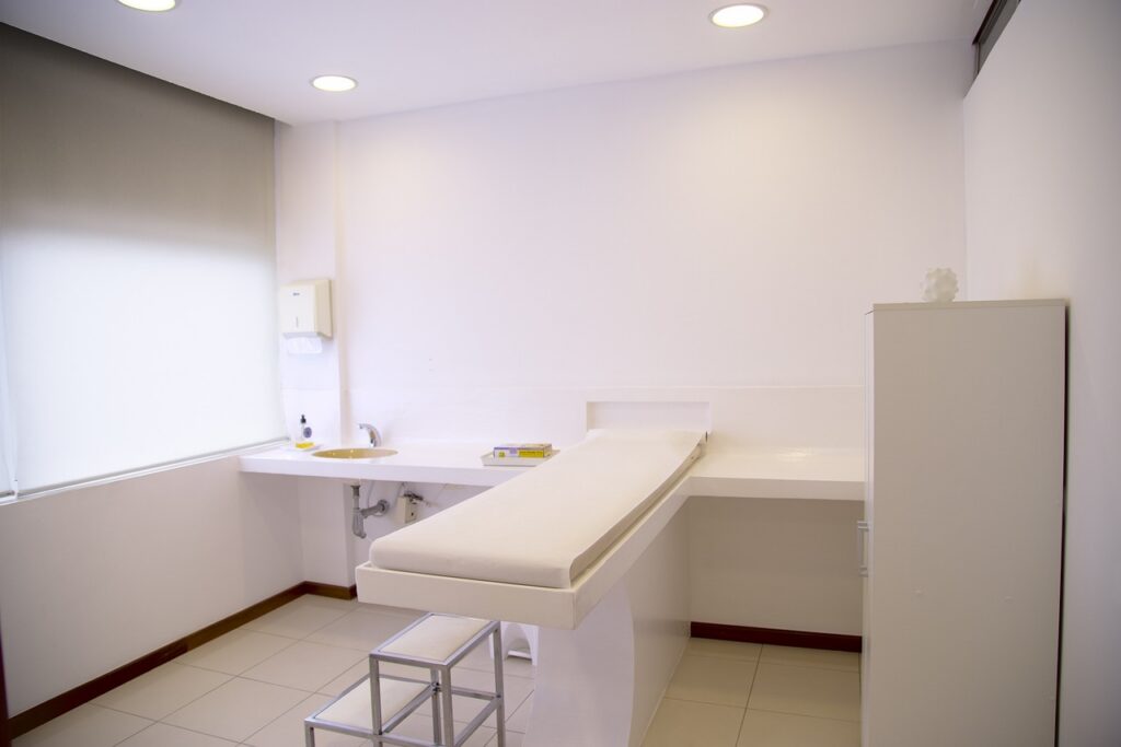 Laser aesthetic treatment device in a med spa treatment room