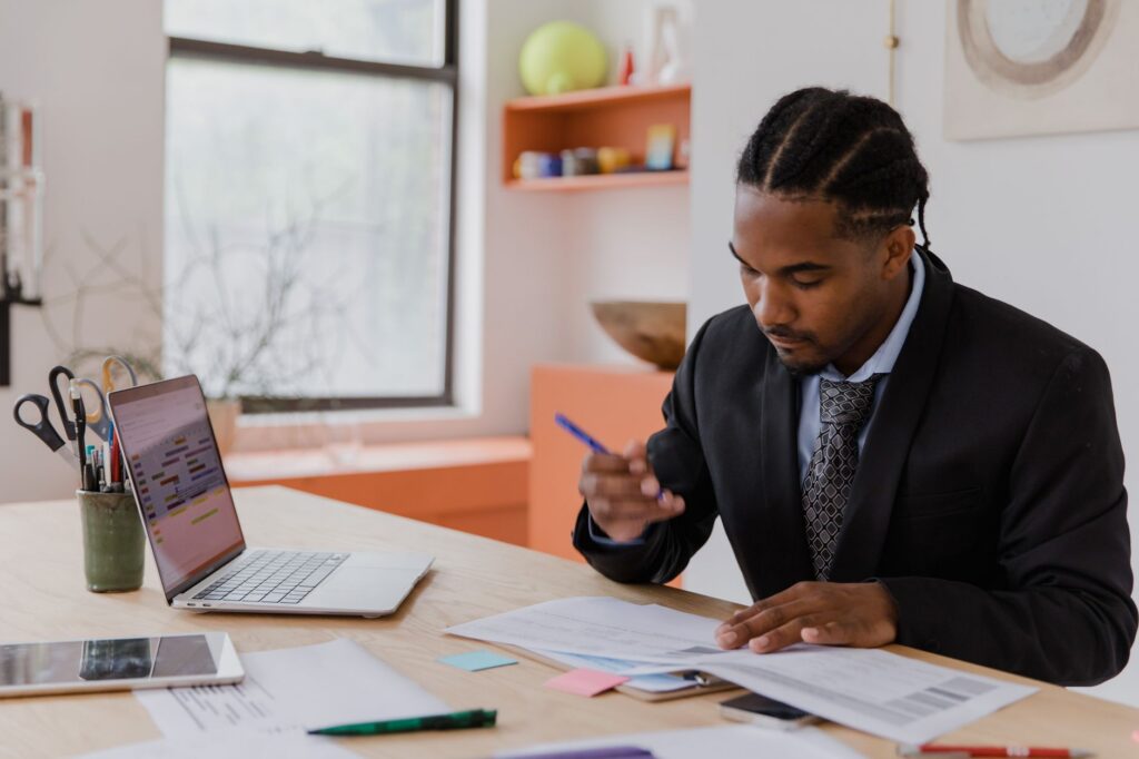 Business owner reviewing equipment loan documents and paperwork at a desk