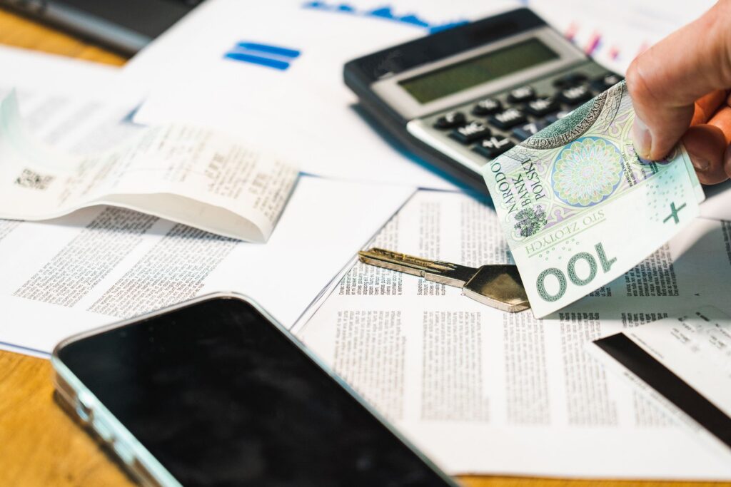 Calculator and unpaid parts invoices on an HVAC contractor's desk