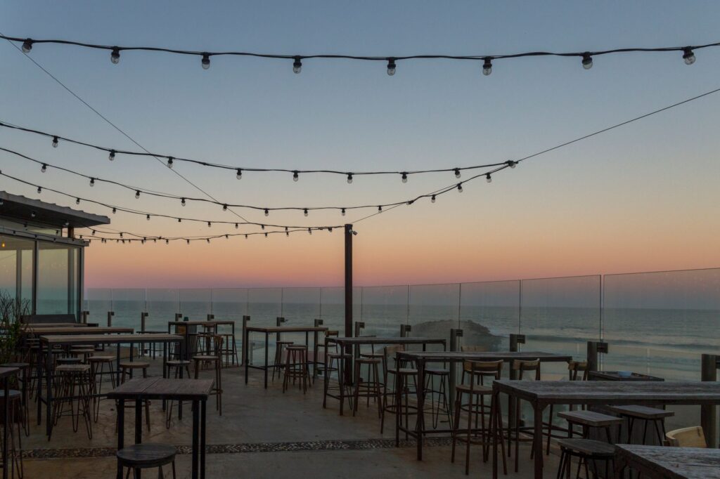 Crowded rooftop bar patio during peak summer season