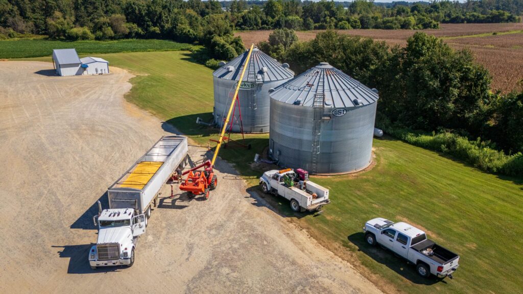 Grain elevator with trucks unloading harvested crops
