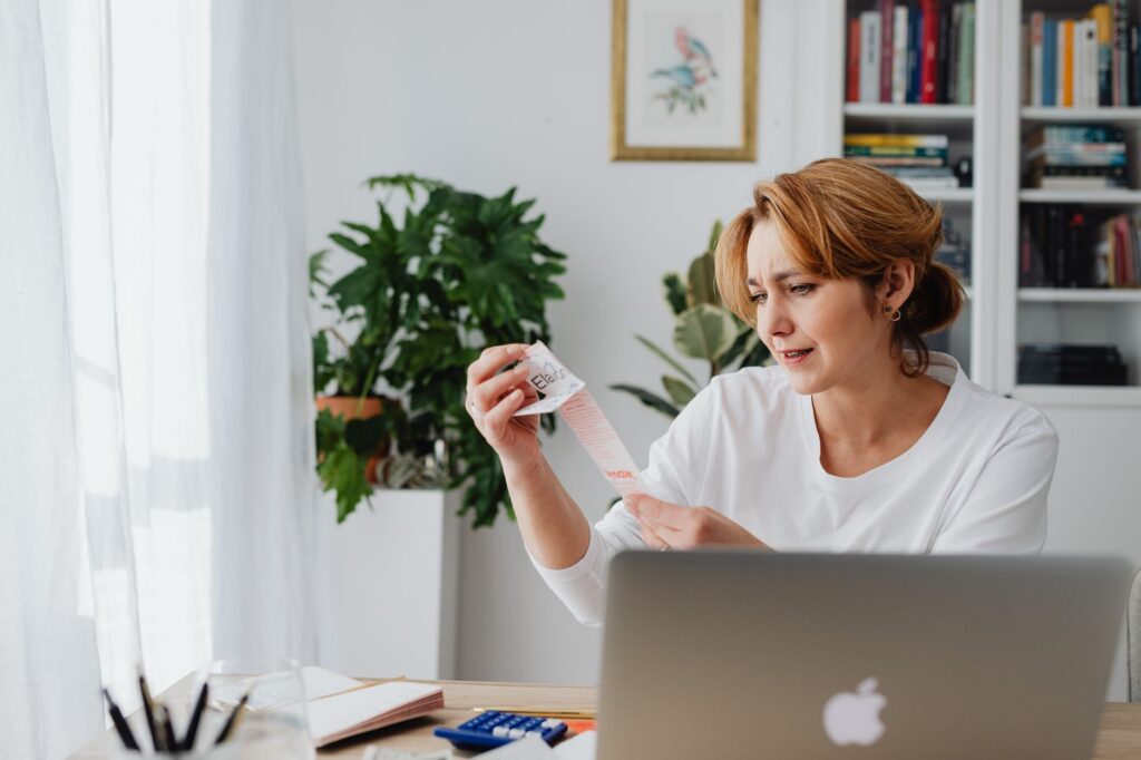 Business owner reviewing a retirement account statement with a concerned expression