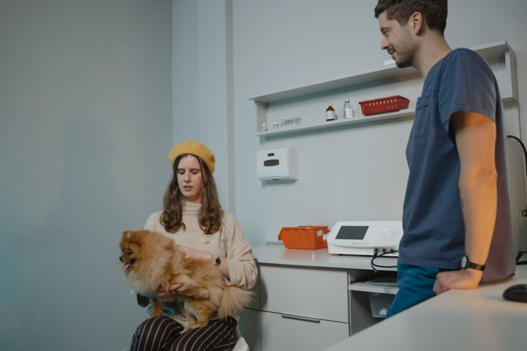 Pet owner waiting with a dog in a veterinary clinic waiting room