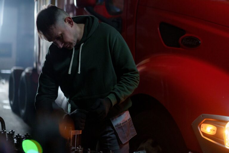 Owner-operator truck driver reviewing freight invoices and bills in the cab