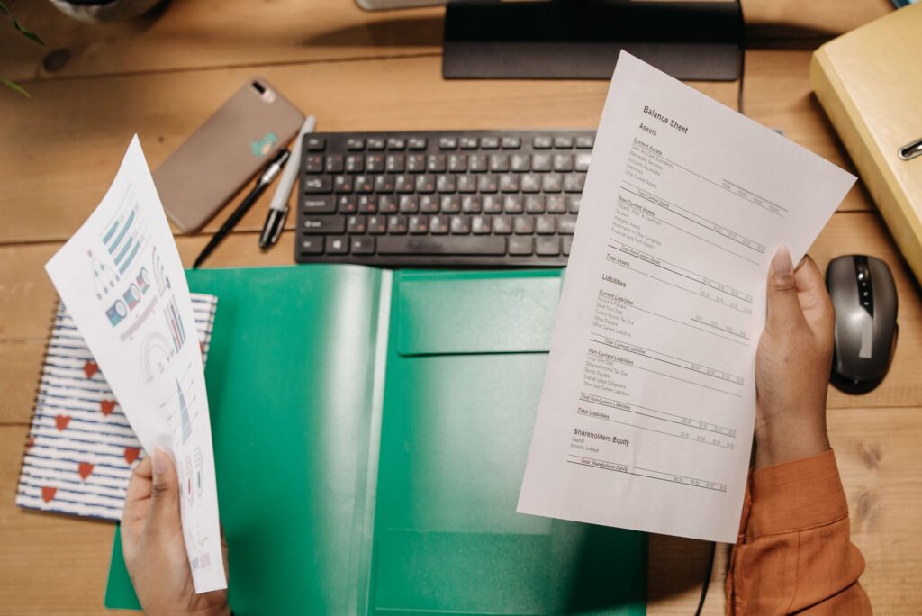 Worried business owner reviewing personal financial documents at home