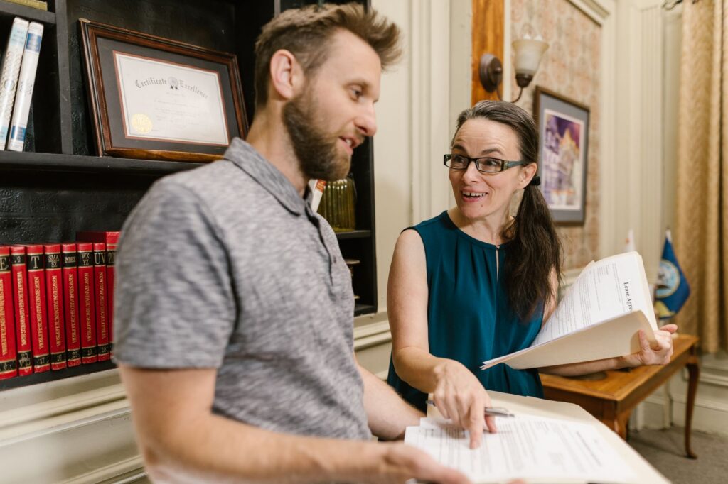 Business owner and attorney discussing business entity structure documents