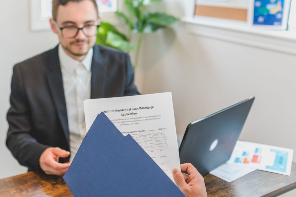 Real estate license and compliance documents displayed on a desk