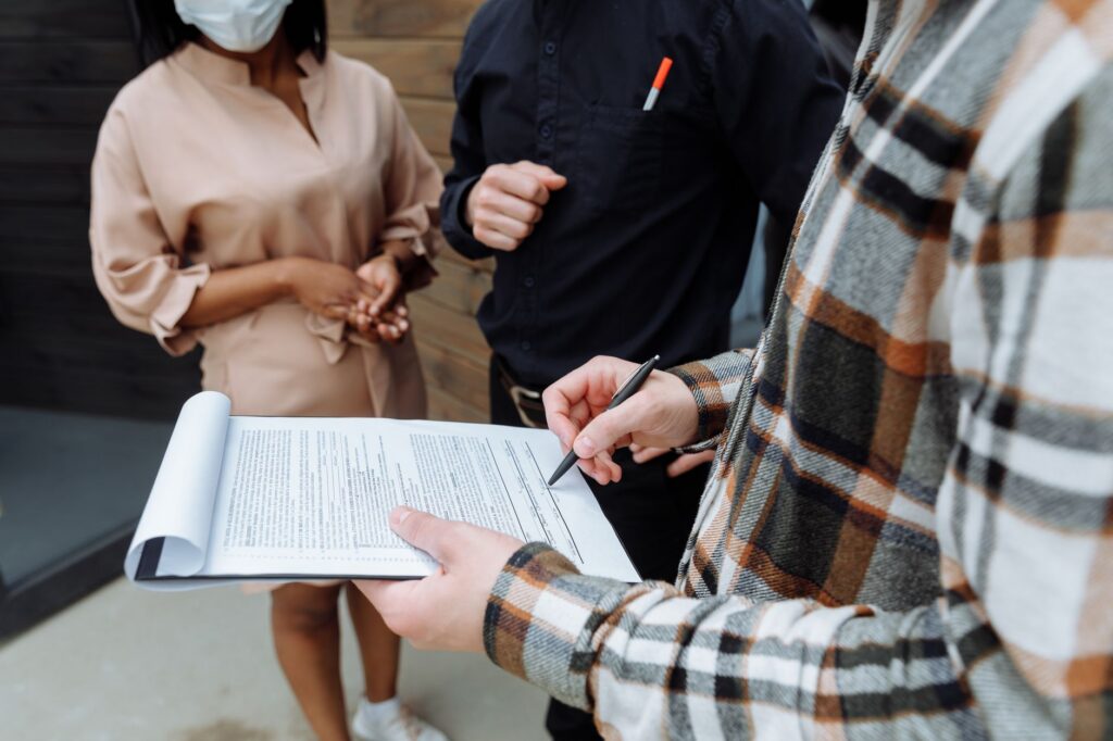 Relieved business owner signing a settlement agreement at a desk