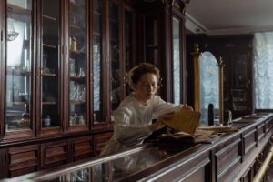 Independent pharmacist reviewing insurance reimbursement paperwork behind the counter