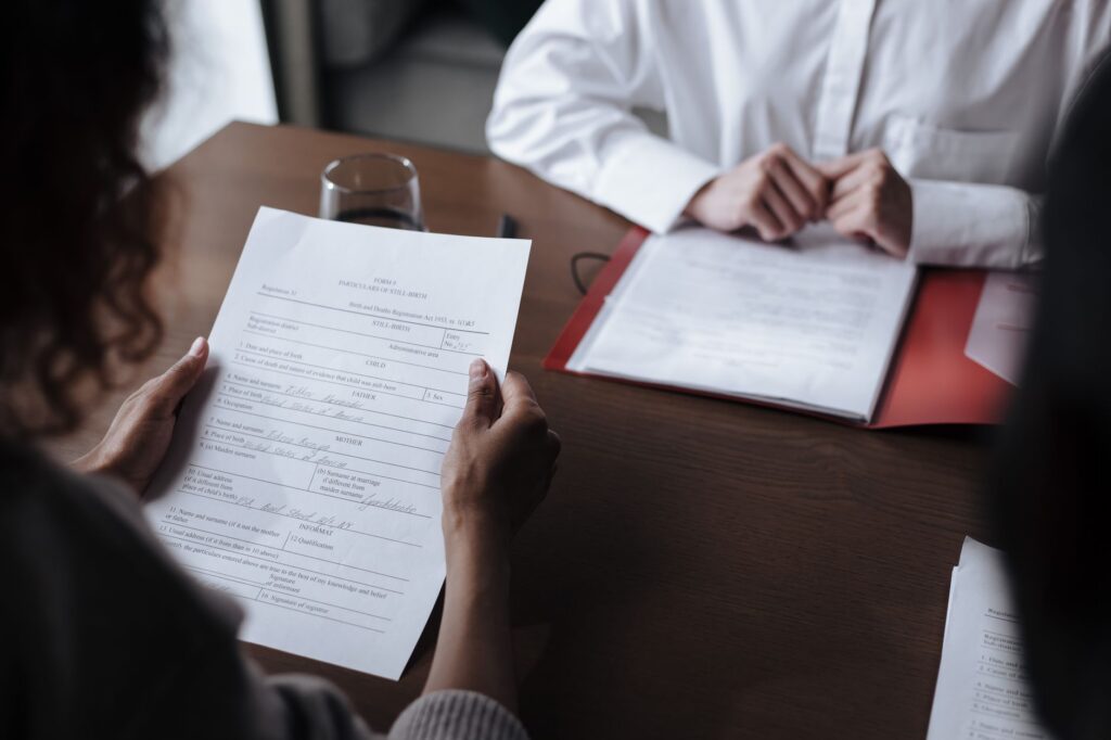 Business owner and advisor negotiating a settlement across a desk