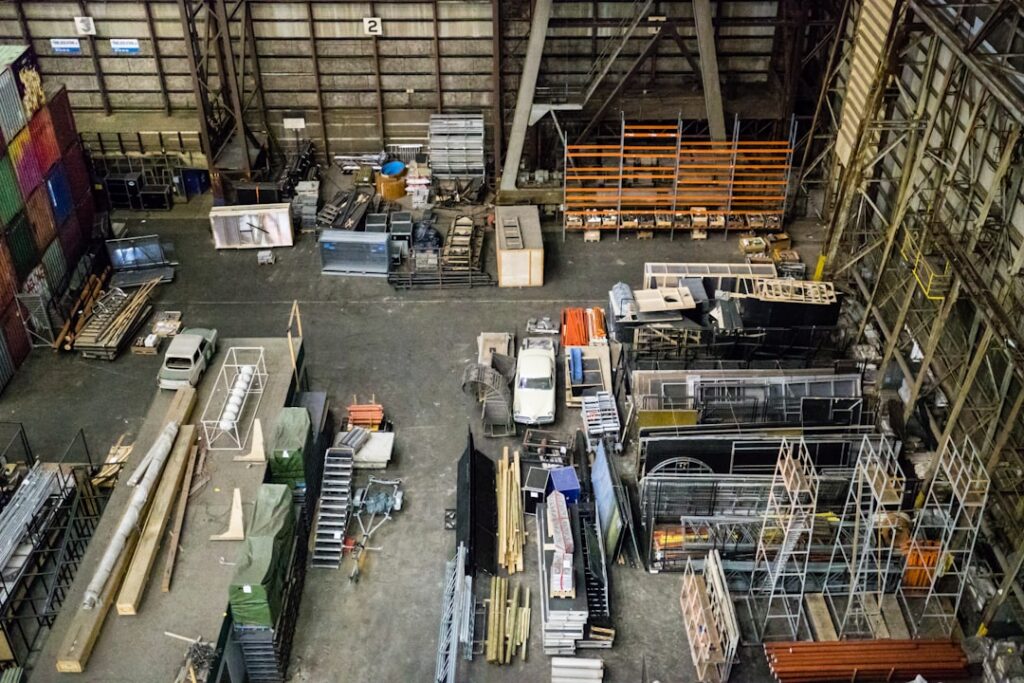 Refrigerant tanks and compressor parts stacked in an HVAC supply warehouse