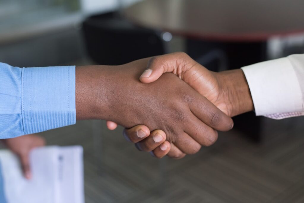 Confident small business owner shaking hands after finalizing an agreement