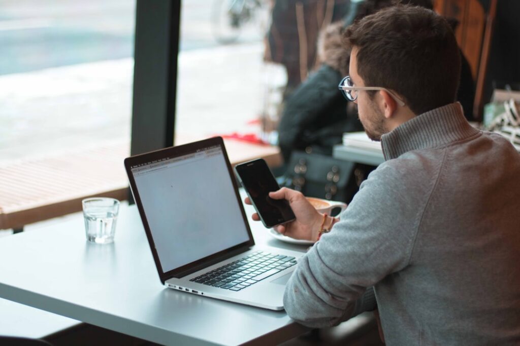Studio owner reviewing bank deposit history on a laptop