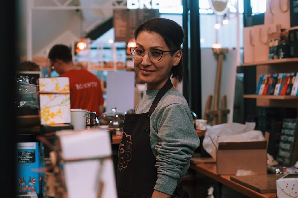 Relieved small business owner standing confidently outside their shop