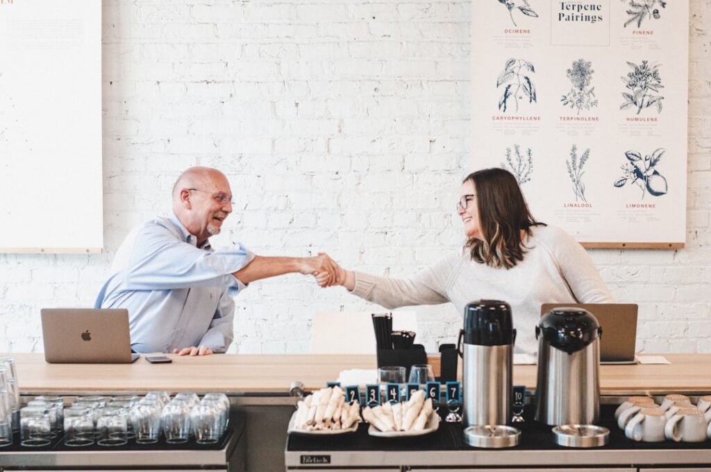 Business owner shaking hands confidently after resolving a debt negotiation