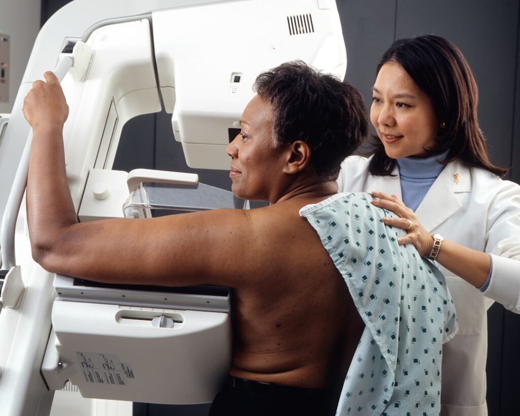 Veterinarian and veterinary technician working with imaging equipment in a clinic
