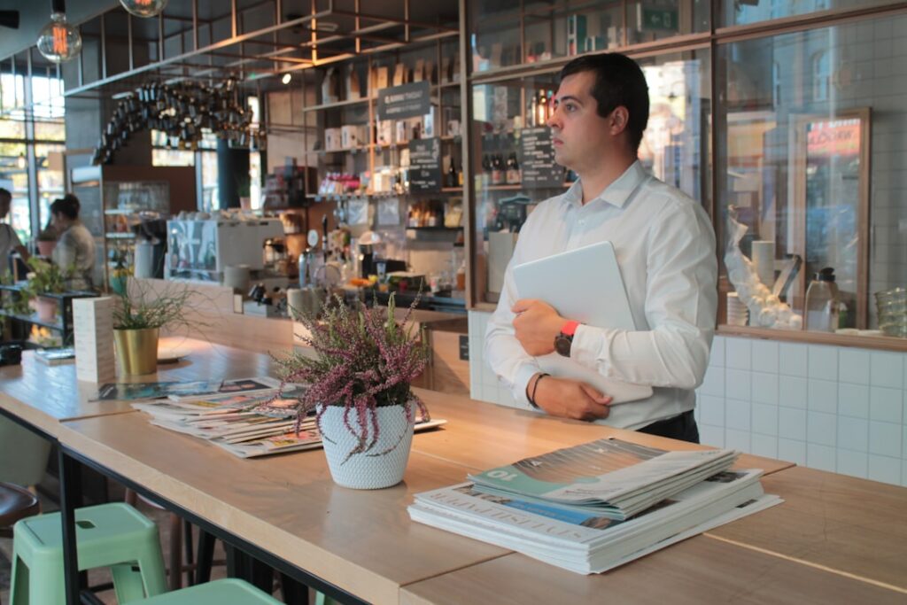 Business owner reviewing daily sales figures against a merchant cash advance debit statement