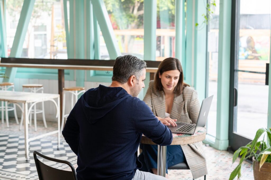 Business owner meeting with an advisor across a desk to review settlement documents