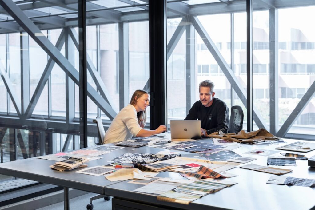 Business owner meeting with an advisor across a desk to review settlement documents