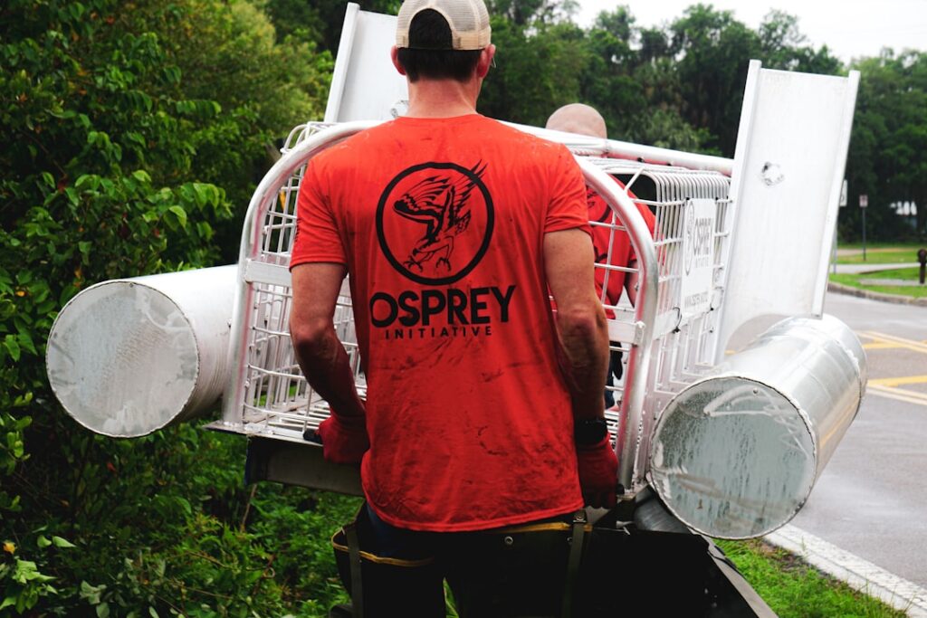Pest control technician loading service truck during peak summer season