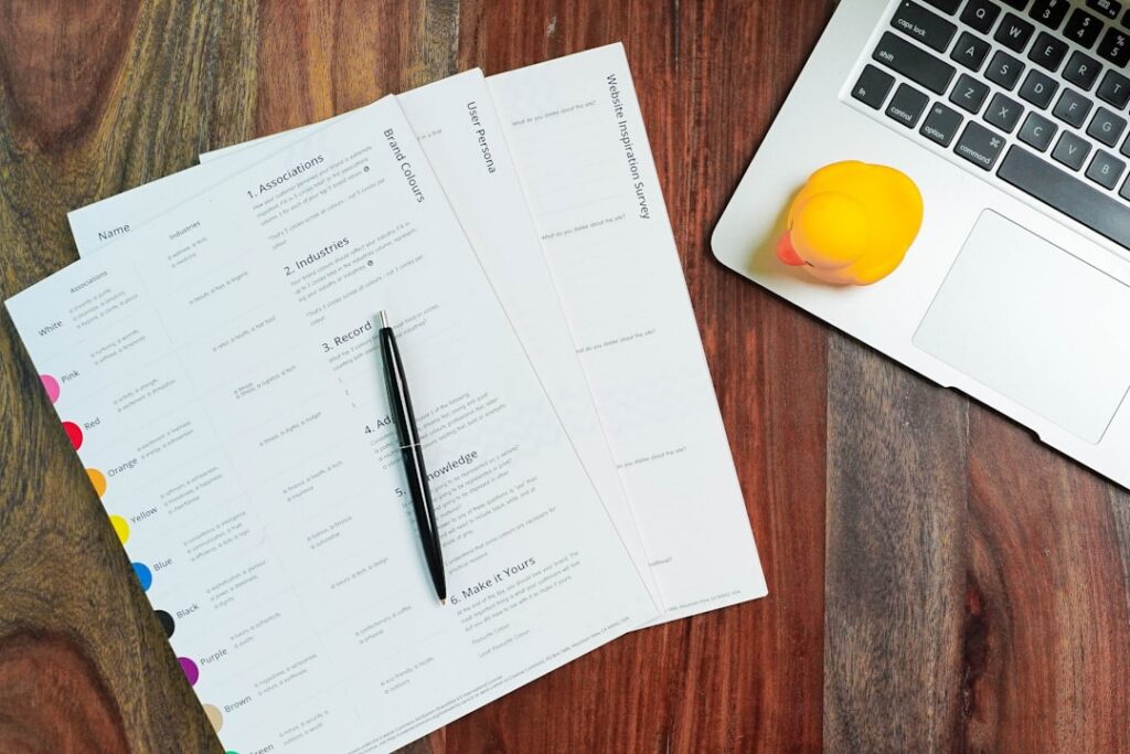 Legal contract document and gavel on a desk beside a laptop