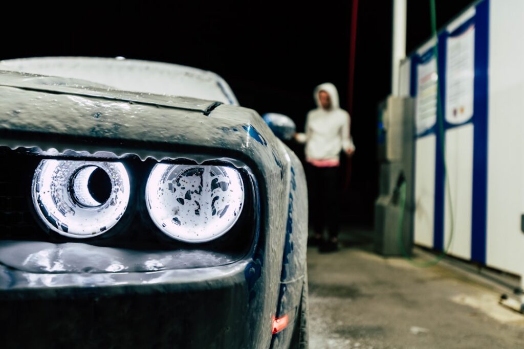 Car wash owner reviewing paperwork in the office of a busy car wash