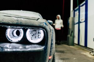 Car wash owner reviewing paperwork in the office of a busy car wash