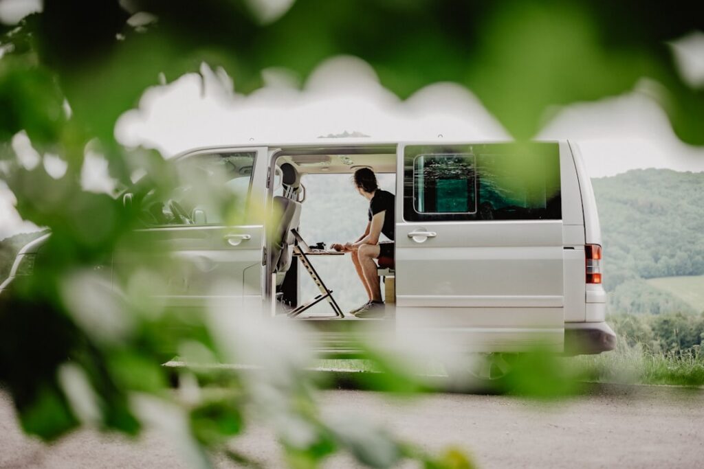 Summer camp director reviewing financial paperwork at an outdoor camp office