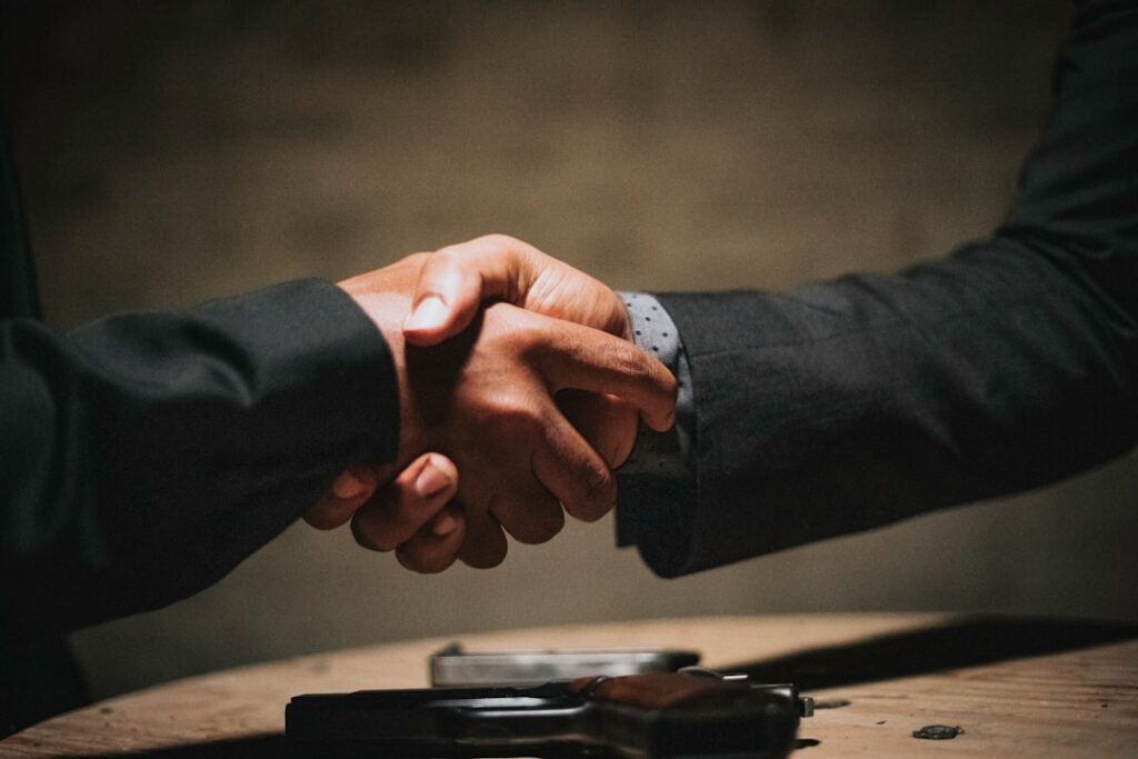 Confident small business contractor shaking hands after finalizing an agreement