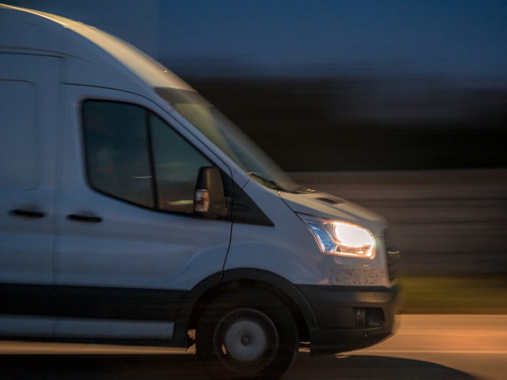 Courier delivery driver loading cargo van before a shift