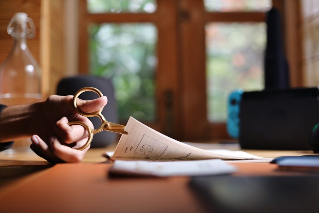 Business owner on an urgent phone call with paperwork spread across the desk
