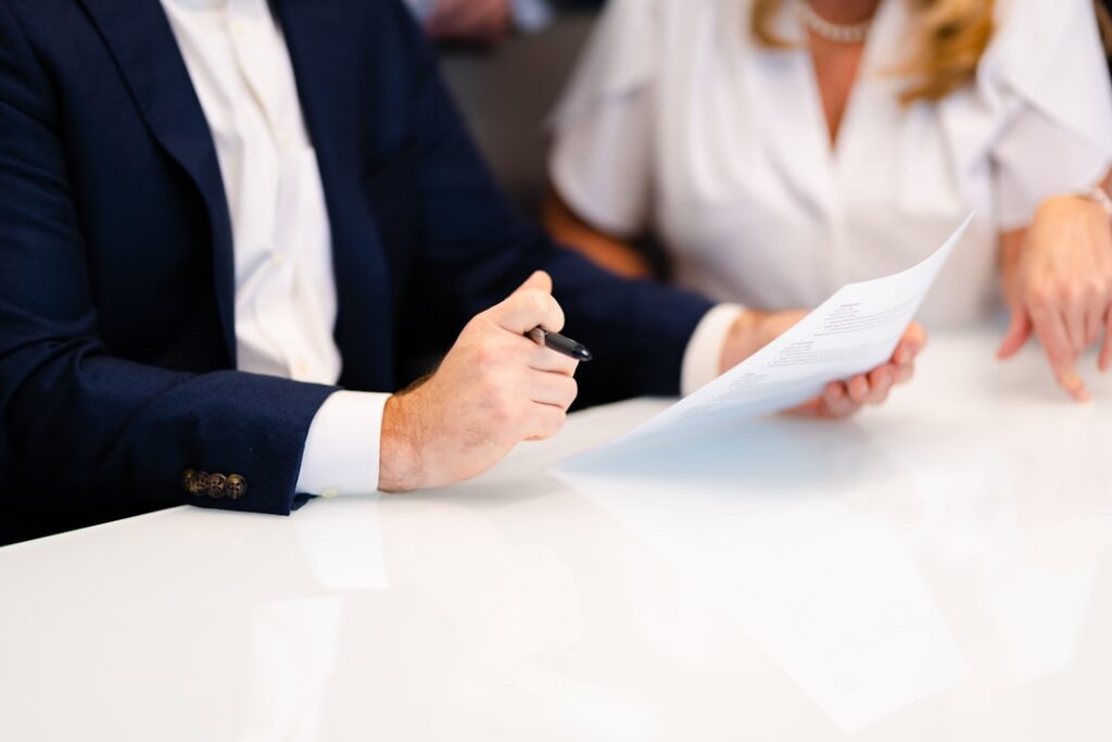 Close-up of a business owner signing a contract