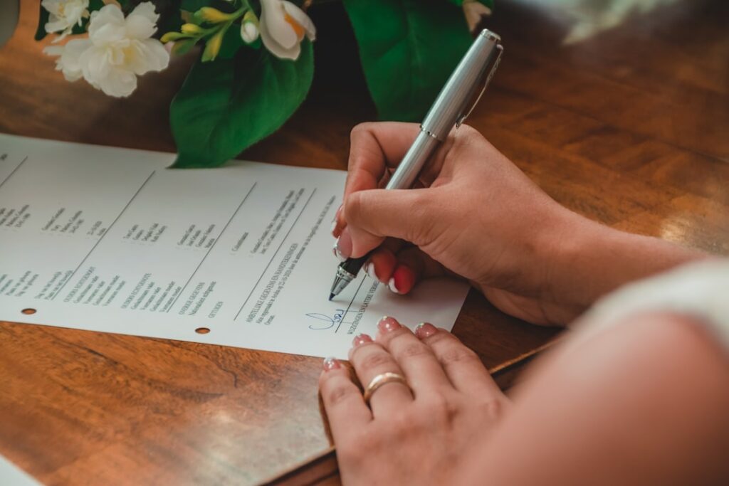 Business owner signing a personal guarantee document with a pen