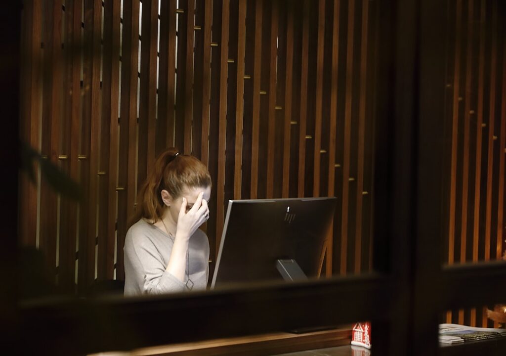 Business owner searching for MCA debt relief options on a laptop at night