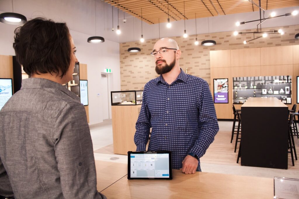 Bank employee explaining account services and forms to a small business owner